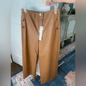 Brown leather pants with gold buttons